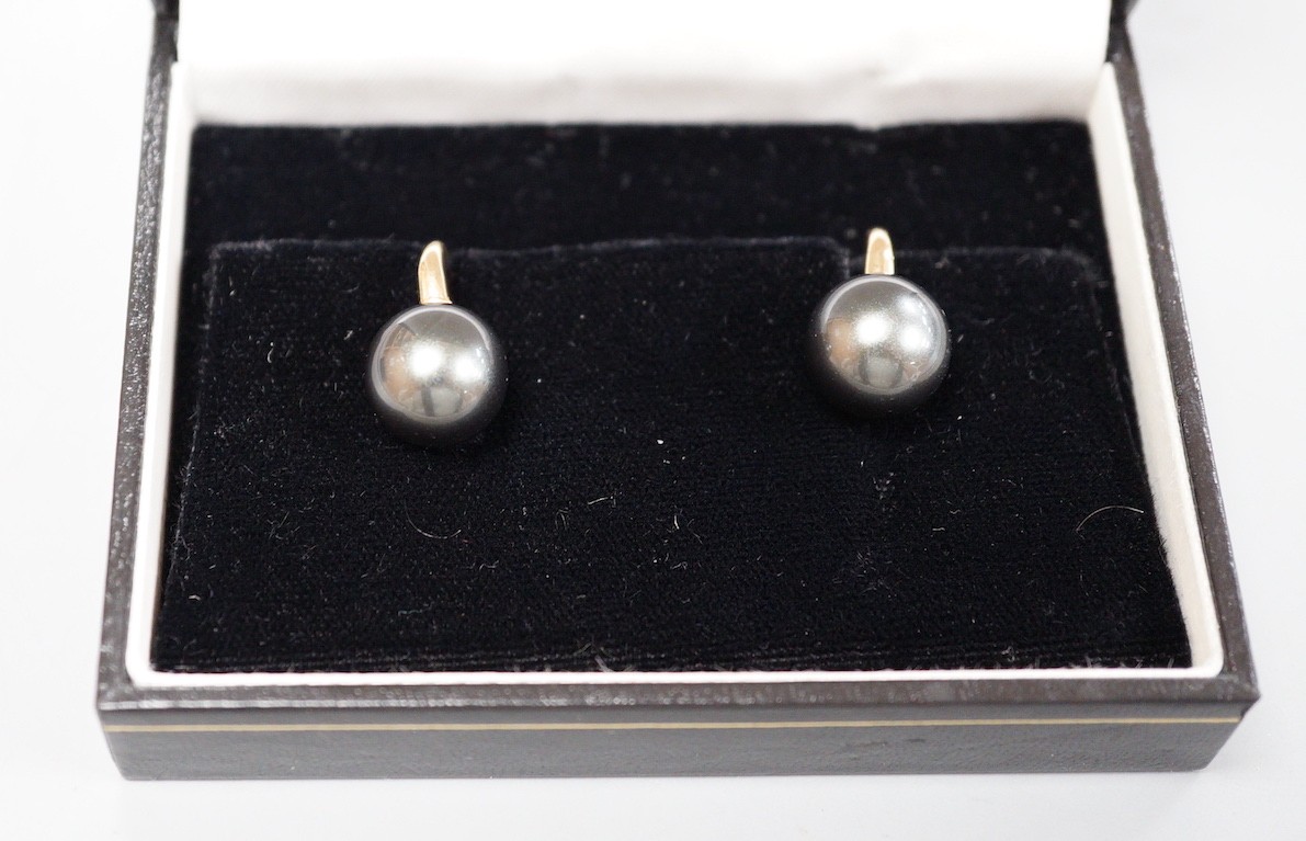 A modern pair of 585 yellow metal and Tahitian style South Sea pearl earrings, diameter approx. 11.8mm and 12.1mm, gross weight 5.9 grams.